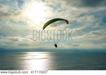 Man Doing Sport, Para-glider In The Clouded Sky. Paragliding Is An Extreme Sport And Recreation. Tor