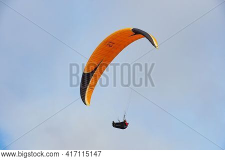 Man Doing Sport, Para-glider In The Clouded Sky. Paragliding Is An Extreme Sport And Recreation. Tor