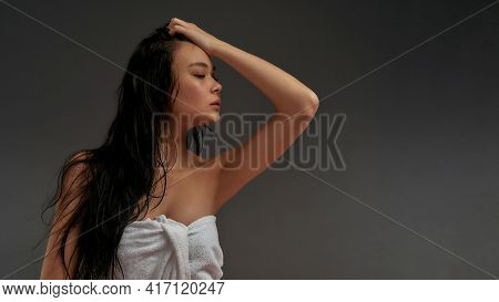 Young Beautiful Asian Half Naked Woman In Bath Towel With Cosmetic Eye Patches On Face Standing Half