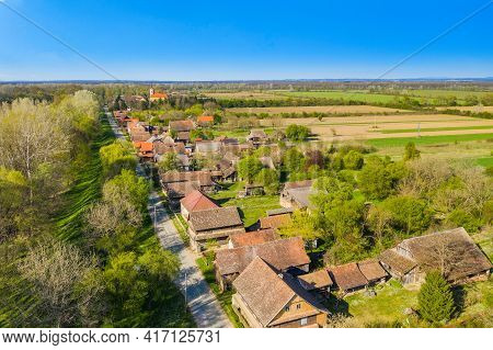 Road And Traditional Village Of Krapje With Typical Wooden Houses In Posavina, Lonjsko Polje, Croati