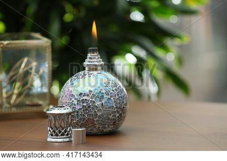 Burning Catalytic Purifying Lamp On Wooden Table, Space For Text. Interior Element