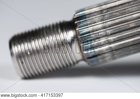 Close-up Thread And Spline Joint Of The Shaft Of The Cv Joint On A Gray Background. Macro Soft Focus