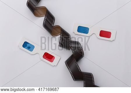Film Tape And 3d Glasses On White Background. Сinema, Entertainment Industry. Top View