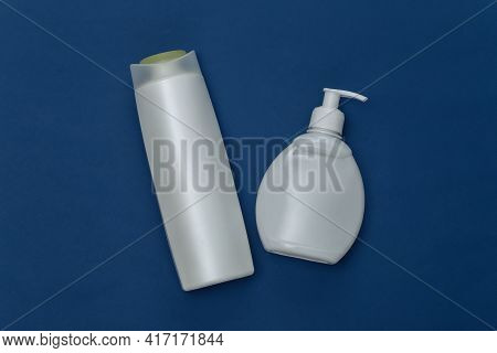 Shampoo Bottles On Classic Blue Background. Color 2020. Top View