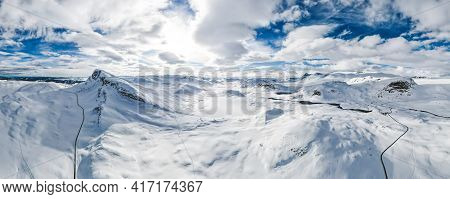 Spectacular Panoramic View Over Snowcapped Mountain Peaks, Ridges And Frozen Highland Tundra In Jotu