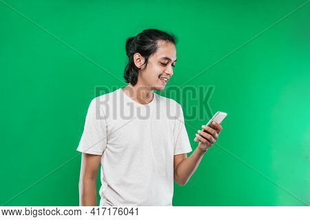 Handsome Asian Man Holding And Look Handphone With Happiness Smile Expression