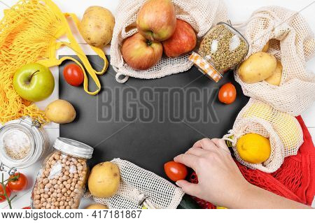Black Chalkboard And Various Vegetables In A Cotton Eco Sacs, String Mesh Bag And Glass Jar With Leg