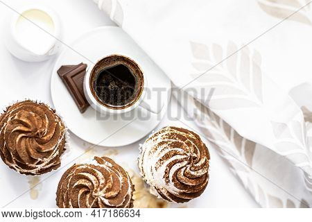 Dark Chocolate And Cocoa Chocolate Cupcakes With A Cup Of Hot Black Coffee. Space For Text