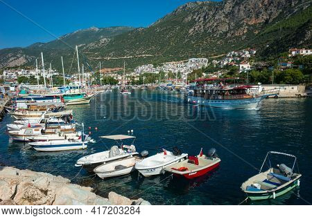 Kas, Turkey - 17 October, 2019: Boats in Kas Marina and mountains on Turkish Mediterranean coast, Popular tourist destination
