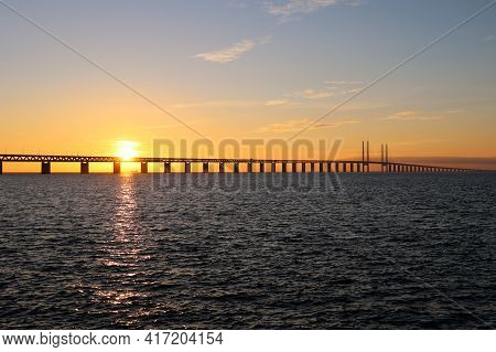 Sunset With The Sun Over The Oresund Bridge At The Viewpoint Near Limhamn, Sweden, In February 2021.