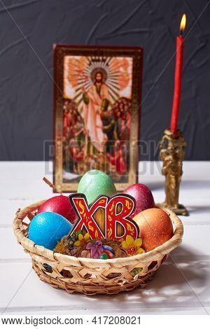 A Wicker Basket With Colored Painted Eggs, Russian Wooden Letters 