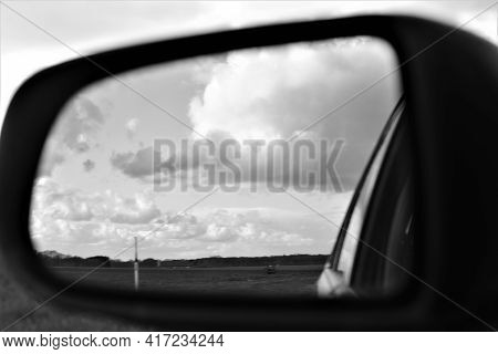 The Landscape Is Reflected In The Exterior Mirror Of A Car As A Monochron Image