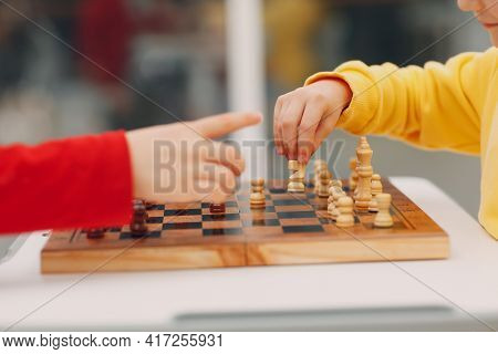 Little Kids Playing Chess At Kinder Garten Or Elementary School