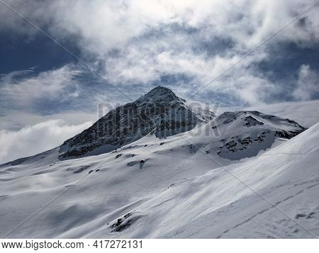View Of The Cloud-covered Fanellhorn In The Canton Of Graubunden. Great Ski Tour Above Valles. Swiss