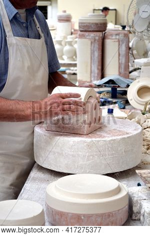 BELLEEK, NORTHERN IRELAND - MAY 19, 2011: Man with molds in Belleek pottery factory, Ireland