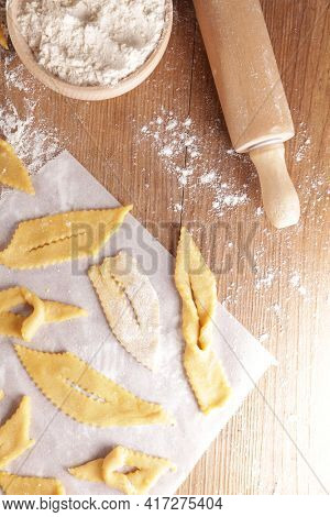 cooking traditional french bugne- carnival cake, angels wings