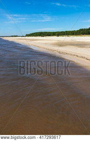 Sand And Lake With Blue Sky