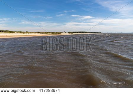 Sand And Lake With Blue Sky