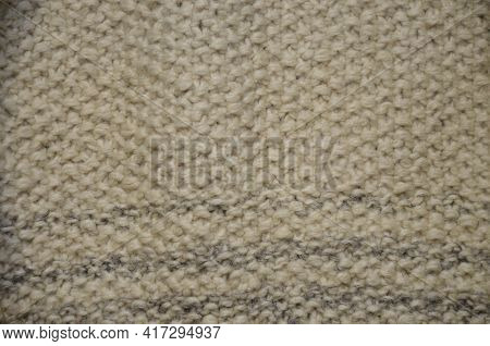 Background Of An Old Worn Carpet Sewn With Thick Threads.