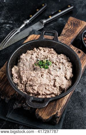 Duck Pate Rillettes De Canard In A Pan With Greens. Black Background. Top View