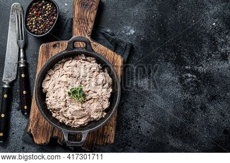 Duck Pate Rillettes De Canard In A Pan With Greens. Black Background. Top View. Copy Space