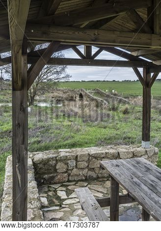 Medieval Bridge Of Santiago De Bencaliz Near The Village Of Aldea Del Cano, Caceres, Spain. Roofed P