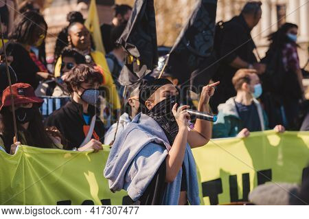 Westminster, London | Uk -  2021.04.17: Person With Microphone In Black Bandana Over Her Face Giving