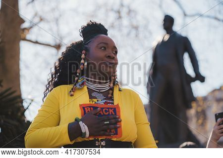 Westminster, London | Uk -  2021.04.17: Lady In Yellow Costume With Black Lives Matter Sign Giving A