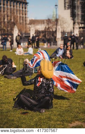Westminster, London | Uk -  2021.04.17: Beautiful Stylish Person Waving The Union Jack Flag At The K