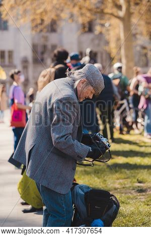 Westminster, London | Uk -  2021.04.17: Elderly Gentleman Changing The Camera Lens At The Kill The B
