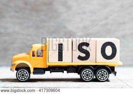 Truck Hold Letter Block In Word Iso On Wood Background