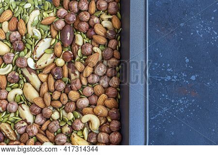 Various Types Of Nuts On Baking Sheet. Roast Cashew, Hazelnuts, Almonds And Brazil Nuts Close Up. He