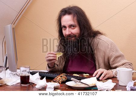 Longhaired Unkempt Man Sitting At The Computer