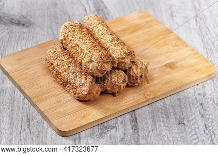 Delicious French Eclairs On Wooden Table. Tasty Dessert. Homemade Cake Eclairs. Sweet Dessert Pastry
