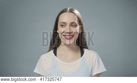 Photo Of Young Smiling Woman On Grey