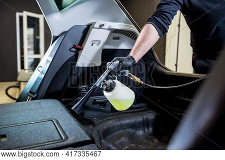 A Car Service Worker Cleans Interiror With A Special Foam Generator