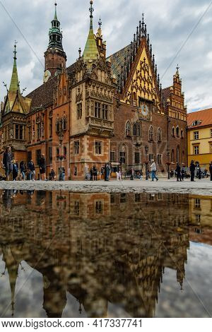 Wroclaw, Poland - June 6 2020: Wroclaw Town Hall Building Reflected In Puddle