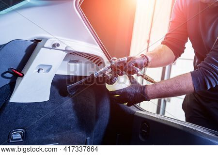 A Car Service Worker Cleans Interiror With A Special Foam Generator