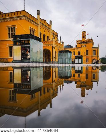 Wroclaw, Poland - June 19 2020: Main Railway Building Reflected In Puddle