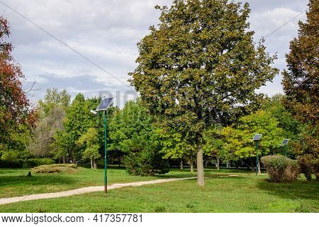 Long Alley And A Lighting Pole Activated With An Attached Blue Solar Panel In Parcul Izvor (izvor Pa