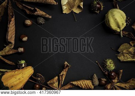 Pumpkin With Glowing Eyes And A Skull On Wooden Background. Sinister Halloween.