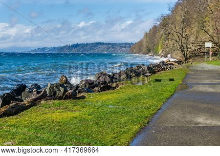Back Rocks Lin The Shore On A Windy Day At Satlwater State Park In Washington State.