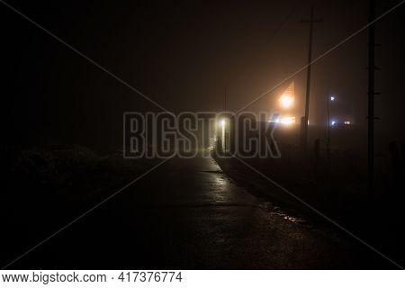 Old House With A Ghost In The Forest At Night Or Abandoned Haunted Horror House In Fog. Old Mystic B
