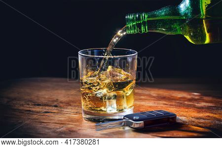 Drinking And Driving Concept. Car Key And Alcohol Glass On Wooden Background. 3D Illustration.