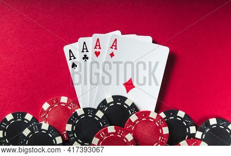 A Poker Game With A Four Of A Kind Or Quads Hand. Chips And Cards On The Red Table. Successful Win