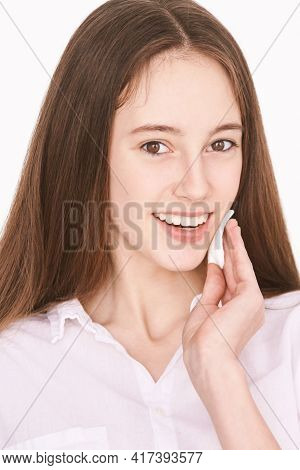 Pretty Girl Indoor Portrait. Light Background. Female Teenager Person. Long Brow Hair. Cleansing Dir