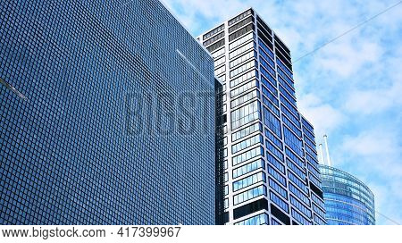 Abstract Closeup Of The Glass-clad Facade Of A Modern Building Covered In Reflective Plate Glass. Ar