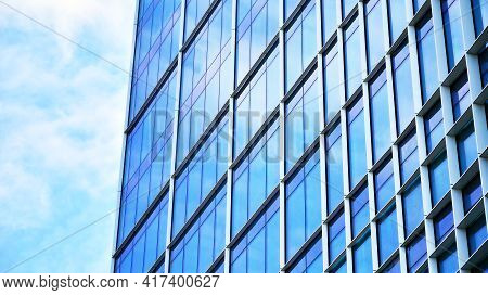 Abstract Closeup Of The Glass-clad Facade Of A Modern Building Covered In Reflective Plate Glass. Ar