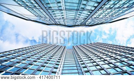 Abstract Closeup Of The Glass-clad Facade Of A Modern Building Covered In Reflective Plate Glass. Ar