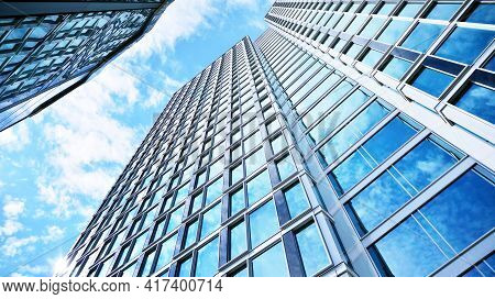 Abstract Closeup Of The Glass-clad Facade Of A Modern Building Covered In Reflective Plate Glass. Ar